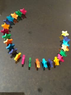 Wooden toys displayed on a natural wood shelf