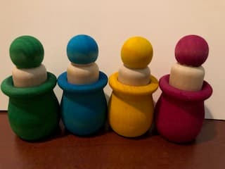 Wooden sorting and matching toys arranged on a natural wood surface