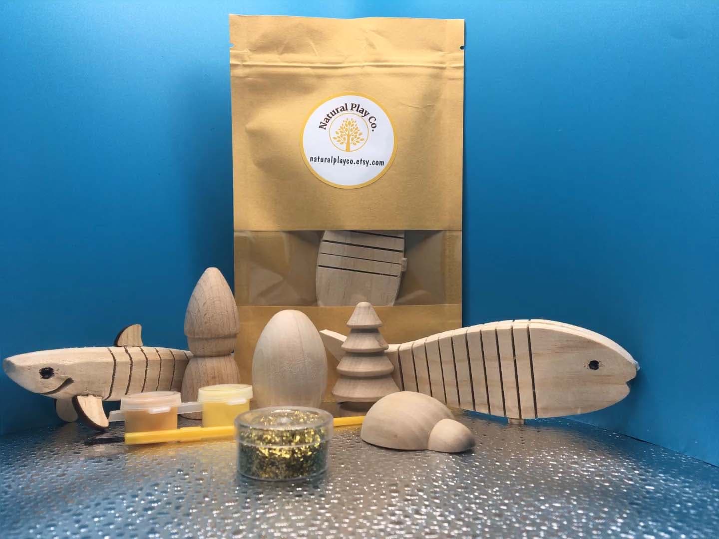 Handcrafted wooden ocean playset with fish, trees, and natural paint set by Natural Play Co.